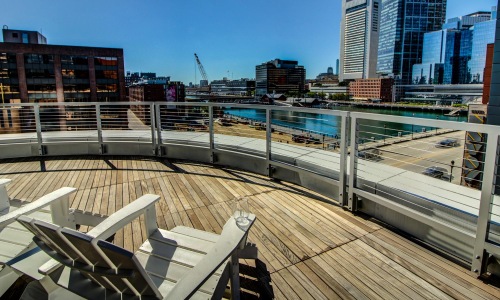 chairs on rooftop deck overlooking waterway