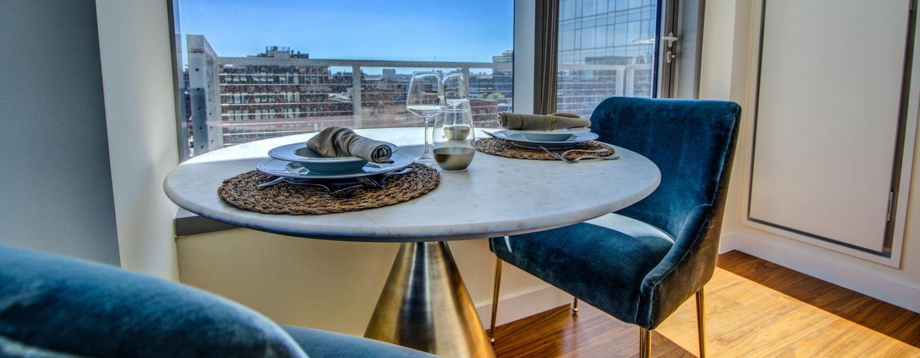 dining table and chairs next to window with city views